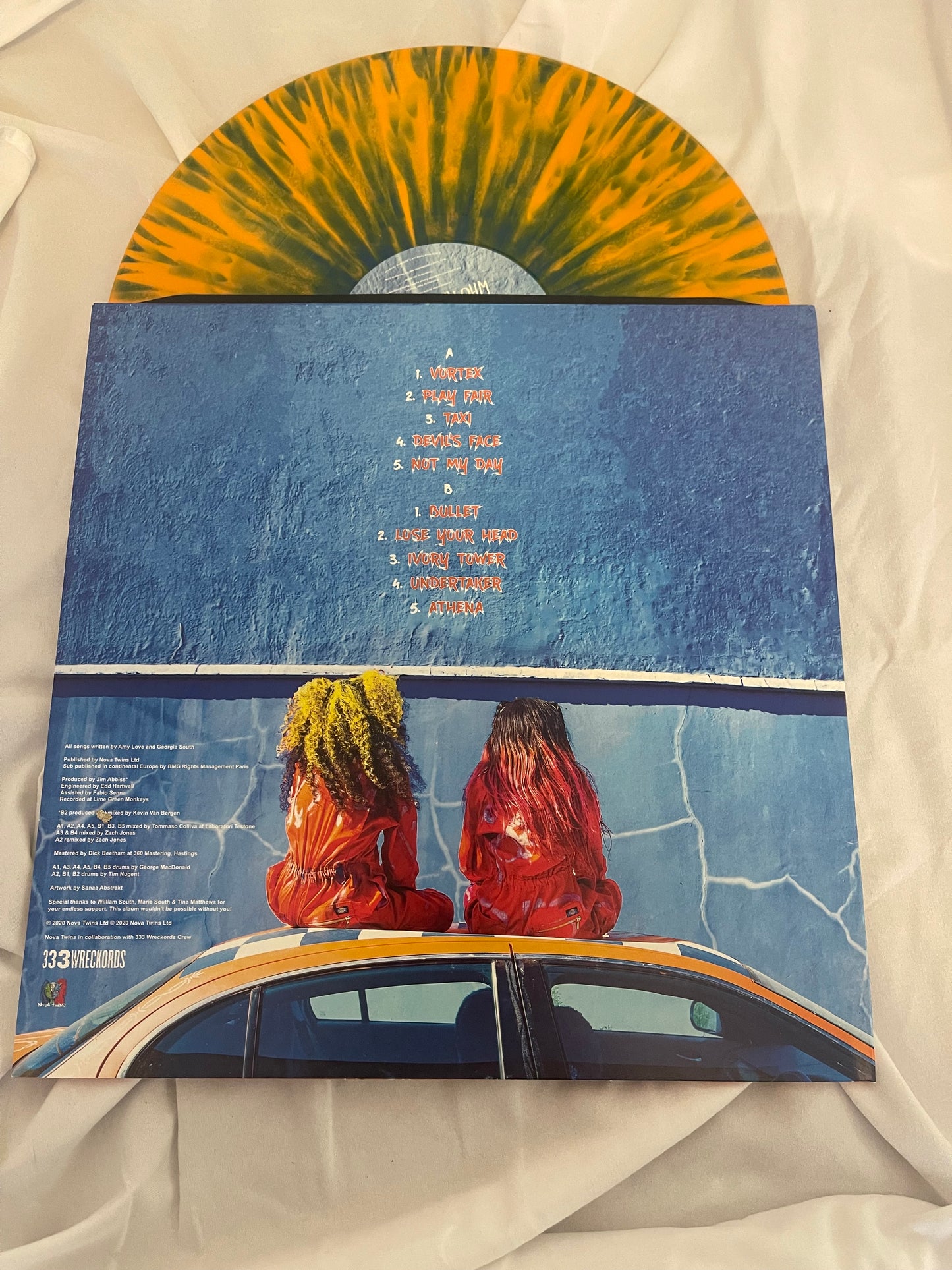 Nova Twins - Who Are The Girls? (exclusive orange and blue splatter vinyl SIGNED COVER)